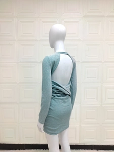 Detail of mint green backless mini dress with shimmering sequin fabric and twist knot