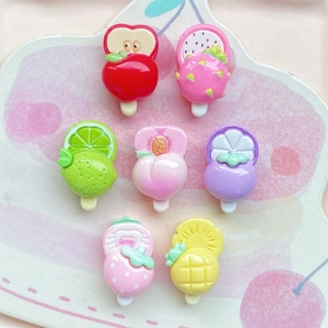 Collection of colorful resin fruit popsicle charms including strawberry and peach designs