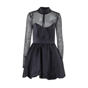 Close-up of elegant black dress featuring sheer mesh sleeves and smooth satin skirt