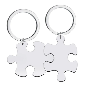 Macro view of polished silver stainless steel puzzle piece keychains for couples