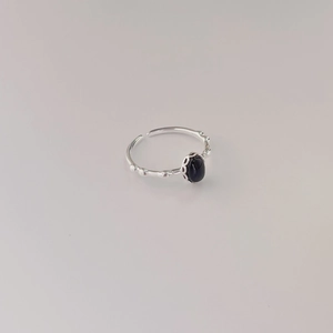 Detailed macro view of 925 sterling silver open ring with black oval gemstone inlay