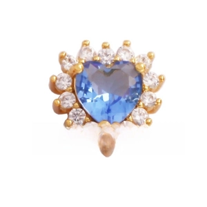 Detail of a gold heart charm featuring a blue gemstone center and crystal halo