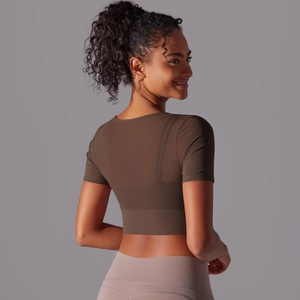 Close-up of dark brown slim fit yoga top featuring breathable mesh fabric and cropped design