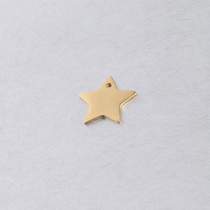 Close-up of a polished gold star-shaped stainless steel pendant charm for DIY jewelry