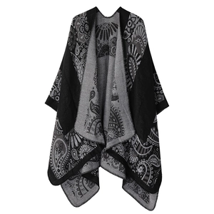 Detail of black and gray knit shawl with paisley pattern and stitched edge finish