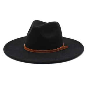 Macro detail of black wool fedora featuring a flat wide brim and brown leather band