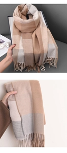 Close-up of soft beige and grey plaid fabric texture with fringe detailing