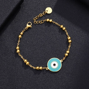 Detail of gold-plated stainless steel bead chain with blue evil eye charm and lobster clasp