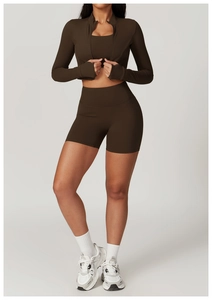 Three-piece dark brown yoga set featuring a zip-up jacket, sports bra, and high-waist shorts