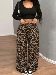 Completo autunnale da donna con crop top nero a maniche lunghe e pantaloni larghi leopardati