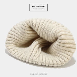 Thick cream knitted beanie hat for men and women with warm minimalist texture