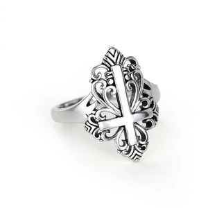 Macro detail of retro oxidized silver ring with inverted cross and hollow wave patterns