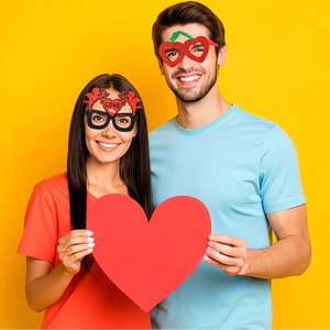 Detail of red glitter heart and Cupid style glasses for Valentine's party photography