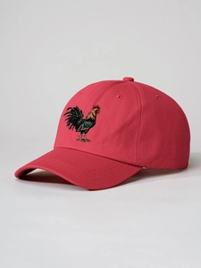 Detail of red cotton baseball cap featuring intricate multi-color rooster embroidery