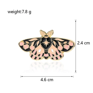 Detailed moth enamel pin with pink and black wings and size dimensions in centimeters