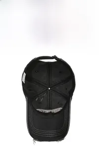 Detail view of washed cotton baseball cap featuring distressed edges and adjustable buckle