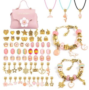 Detail of pink DIY charm bracelet kit with golden beads, unicorn pendants and handbag