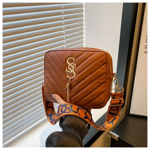 Brown crossbody bag featuring a golden SSS logo and wide patterned strap detail