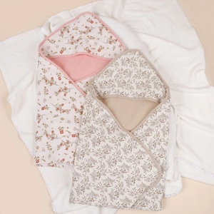 Two-pack of breathable cotton gauze hooded baby towels with floral prints for infants