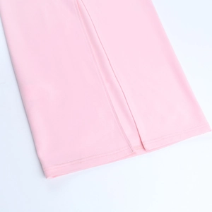Detailed view of the pink mermaid gown hem featuring a high slit and premium stitching