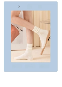 Detail of cream white slouch socks in soft cotton showing the stylish textured ribbing