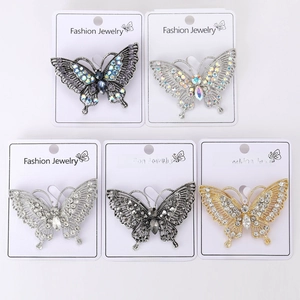 Detailed close-up of butterfly brooches with crystal inlay in five elegant color variations