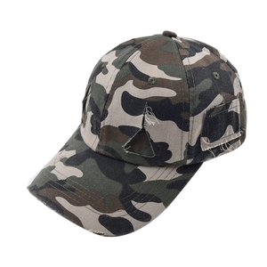 Detail of distressed camouflage baseball cap with torn fabric effects and side patch