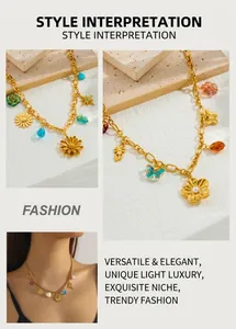 Close-up of gold chain necklace featuring vintage heart, butterfly and shell charms