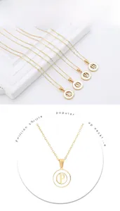 Macro detail of gold hollow letter charms on a hip hop style minimalist necklace