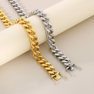 Close-up of gold and silver 13mm Cuban link chains with hip-hop dragon box clasps