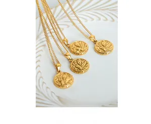 Macro detail of retro round gold-plated flower relief pendants on fine chain necklaces