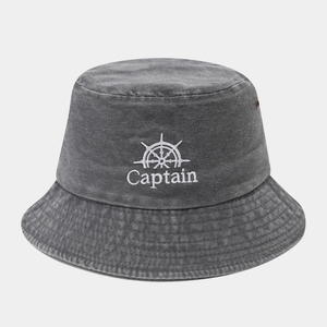 Close-up of white Captain embroidery and helm logo on dark grey washed denim bucket hat