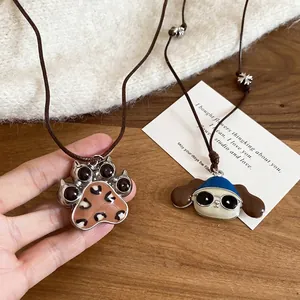 Puppy and leopard paw print pendant necklaces on adjustable brown wax cords