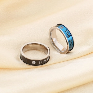 Macro shot of silver titanium rings with diamond inlay on elegant silk fabric