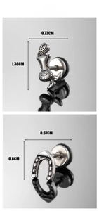 Macro detail of mermaid and horseshoe studs in vintage stainless steel with screw backs