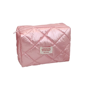 Pink quilted puffer makeup bag with pearl finish and romance quote label on white background