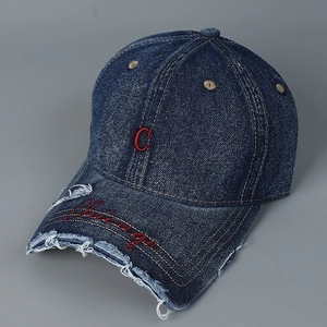 Close-up of red C embroidery and Chicago script on distressed blue denim baseball cap