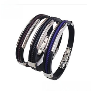 Detailed view of three stainless steel silicone bracelets in black, purple and burgundy