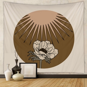 Detail of bohemian tapestry with sun and flower illustration on textured wall decor