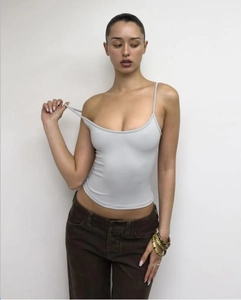 Detail of light gray slim fit U-neck tank top paired with brown corduroy pants