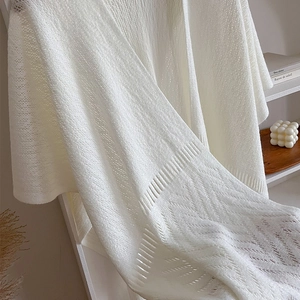 Elegant off-white hollow-out knitted shawl cape with tassels and wavy texture design