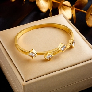 Elegant gold titanium steel open bangle featuring square green and pink gemstones
