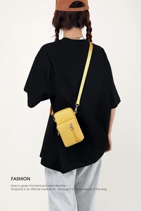 Detailed back view of model wearing a vibrant yellow crossbody phone bag with nylon strap