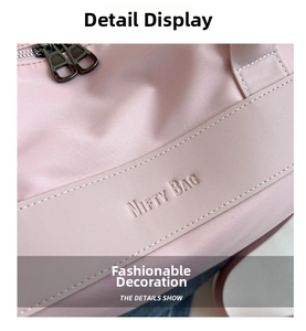 Detail of pink sports bag showing NIFTY BAG embossed strap and neat stitching