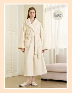 Detail of creamy white plush bathrobe with thick faux fur collar and cozy waist tie