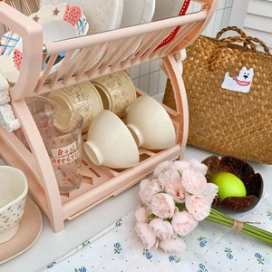 Detail of pink double-tier kitchen drying rack with bears pattern bowls and plates