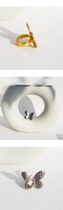 Three-way view of 3D gold and silver butterfly rings with intricate wing textures