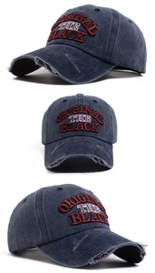 Detail view of vintage washed navy baseball cap with 3D embroidery and distressed brim