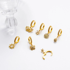 Detailed set of 7 gold earrings with zircon pendants featuring stars and butterflies