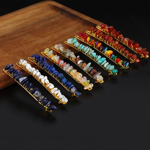 Natural crystal stone hairpins in various vibrant colors on a wooden tray with black background